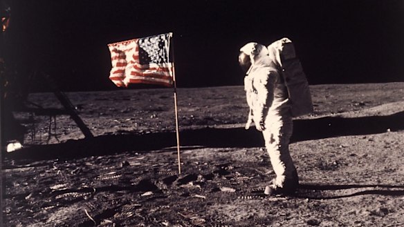 Astronaut Edwin "Buzz" Aldrin poses for a photograph beside the US flag planted on the moon during the Apollo 11 mission on July 20, 1969. 