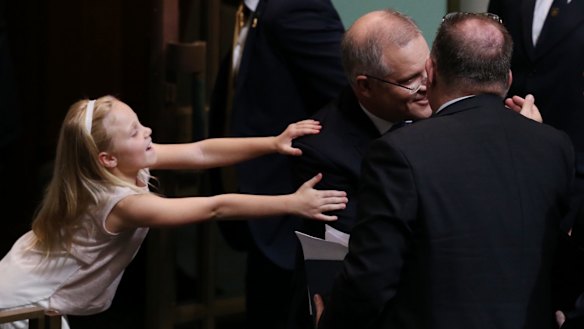 Treasurer Scott Morrison is hugged by his daughter after he gave the budget address on Tuesday.