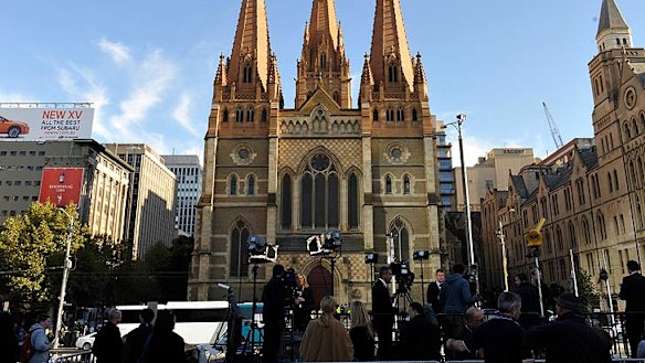 A large media contingent sets up outside the cathedral.