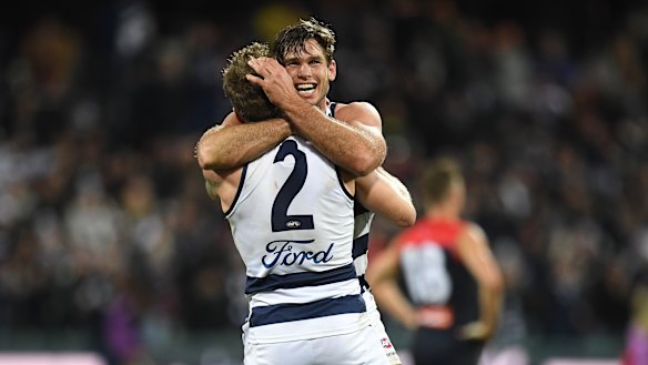 Tom Hawkins hugs Zach Tuohy after his match-winning goal.