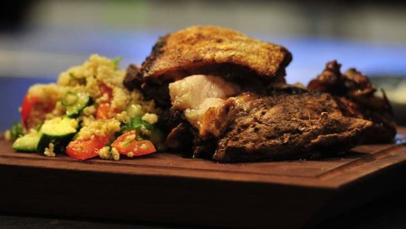 Panela and chilli-rubbed pork shoulder with baby onions and quinoa salad.