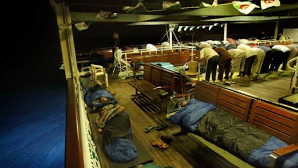 Activists sleep and pray on the Turkish passenger ship MV Marmara carrying 600 activists, part of the freedom flotilla headed to Gaza.