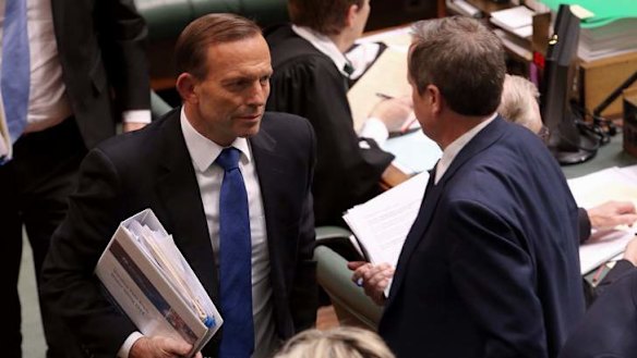 Prime Minister Tony Abbott and Opposition Leader Bill Shorten pass after a division in Parliament House. Photo: Andrew Meares