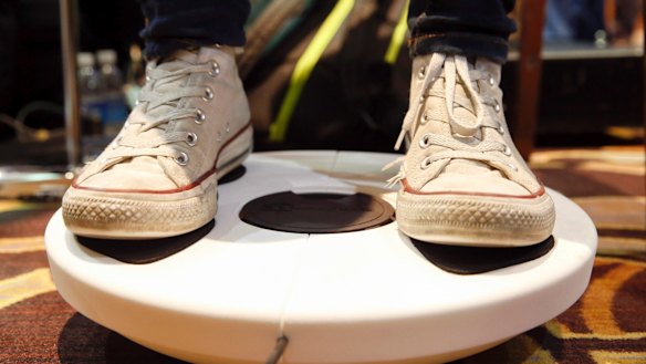 An attendee uses the 3DRudder motion controller to navigate a virtual world.