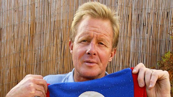 Former Footscray player Alan Stoneham with the famous Ted Whitten jumper that he wore when he started at the club.