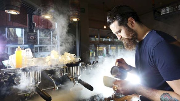 Steaming success: Barista Sean McManus makes a coffee at Single Origin Roasters in Surry Hills. The cost of coffee is predicted to reach $4 in the next few years.
