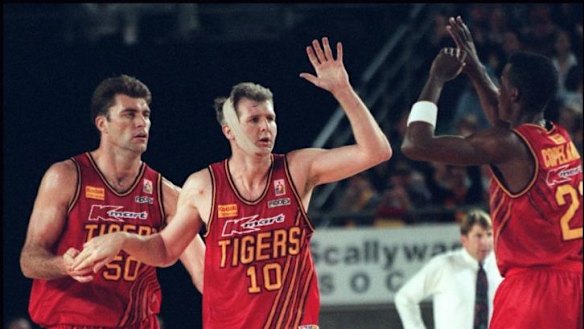 Mark Bradtke, Andrew Gaze and Lanard Copeland celebrate a basket during the mid-1990s