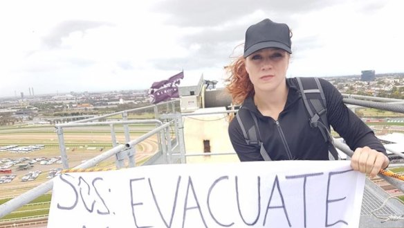 Protesters against Manus Island unfurled a banner on a crane at Flemington Racecourse on Melbourne Cup Day.