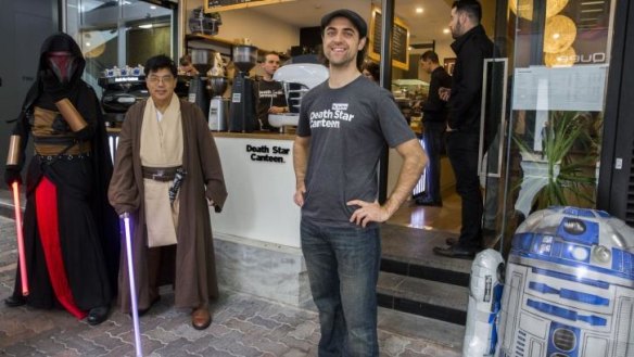 Death Star Cafe co-owner Glenn Morris with Star Wars fans in costume.
