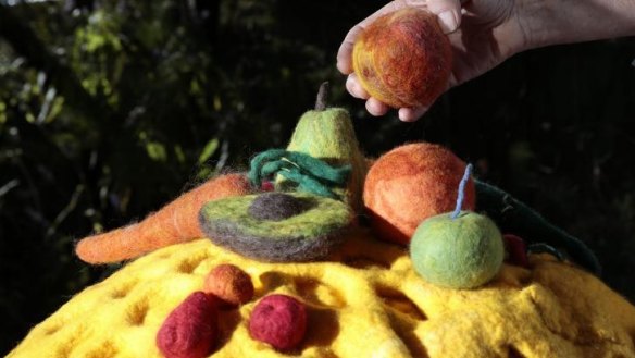 Julie Armstrong has made  large felt   fruit and vegetables that attract bees and a a honeycomb.