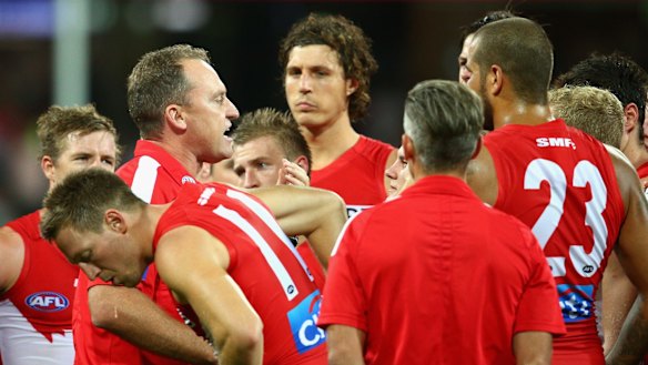 Come on boys: Swans coach John Longmire talks to his players during an interval.