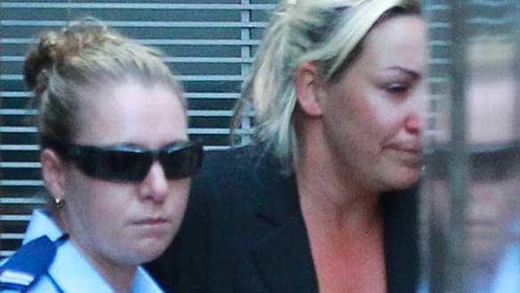 Kelli Lane being led away by security officers at the Supreme court.