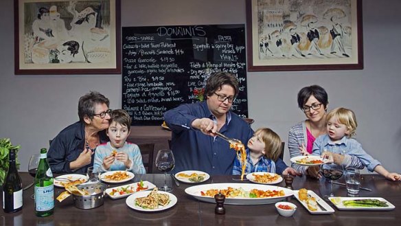 Bring the family: The Donninis gather for lunch at their Carlton restaurant. They are (left to right) Marco's mum, Ruthie, with Frankie, Marco with Rocky and wife Kim with Leo.