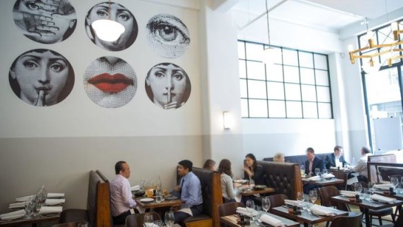 Fornasetti wallpaper makes a striking feature at Massi in Melbourne.