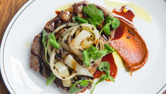 Bavette steak served with charred onion, watercress and harissa.