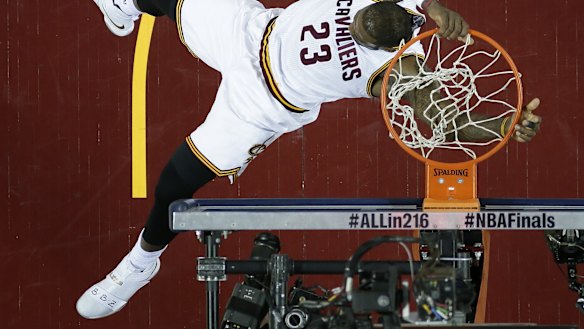 Spectacular: Cleveland Cavaliers forward LeBron James dunks against the Golden State Warriors during Game 6 of the NBA Finals in Cleveland.