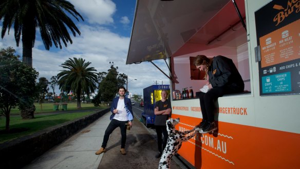 Jack White of The Brulee Cart owner (left) and Riley Woosnam and Maddison Chadderton of Mr Burger at Yarraville Gardens. 