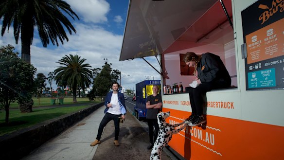 Jack White of The Brulee Cart owner (left) and Riley Woosnam and Maddison Chadderton of Mr Burger at Yarraville Gardens. 