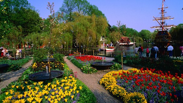 The colourful spring floral display at Tivoli Gardens in Copenhagen with the pirate ship St Georg behind.