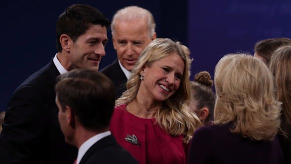 Brittle and passionate debate ... Paul Ryan's wife, Janna, centre, speaks to Joe Biden's wife, Jill, as Mr Ryan, left, and Mr Biden look on following the vice-presidential debate.