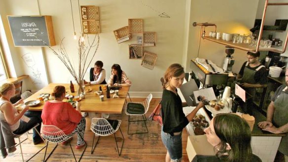 The cafe's interior features copper piping and paste-ups.