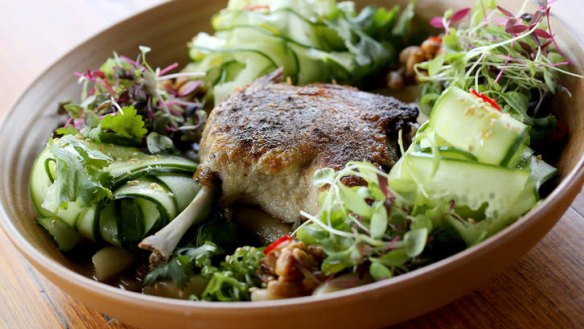 Five-spice confit duck leg sits atop noodles and salad.