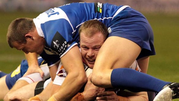 Attack Dog ... Canterbury centre Josh Morris pins his former teammate Beau Scott to the ground as the Bulldogs beat St George Illawarra for the second time this season.