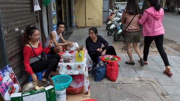 Nguyen Thu Hong, a street vendor, sells a tofu-and-noodle dish called bun dau from the sidewalk in Hanoi.  Major cities in Vietnam, Thailand and Indonesia are strengthening campaigns to clear the sidewalks, driving thousands of food vendors into the shadows and threatening a culinary tradition.