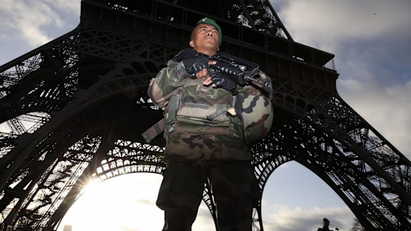 Armed military patrol the Eiffel Tower Paris France on Sunday 15 November 2015.