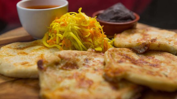 Pupusas with refried beans and pickled cabbage.
