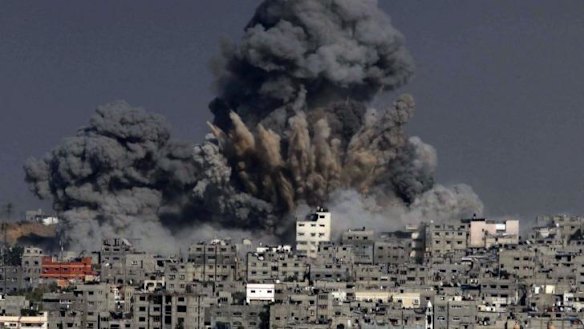 Costly rebuilding: heavy smoke billows following an Israeli military strike in Gaza City.