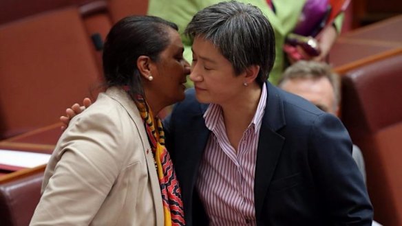 Senator Nova Peris is embraced by Opposition Leader in the Senate Penny Wong following her statement. 