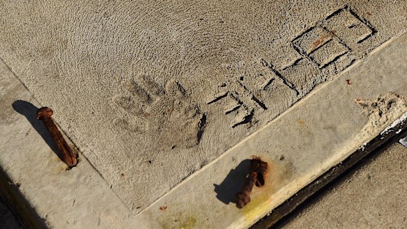 Jeff Lindsell's four-year-old hand print in the driveway of his family home in Gymea, Sydney. 