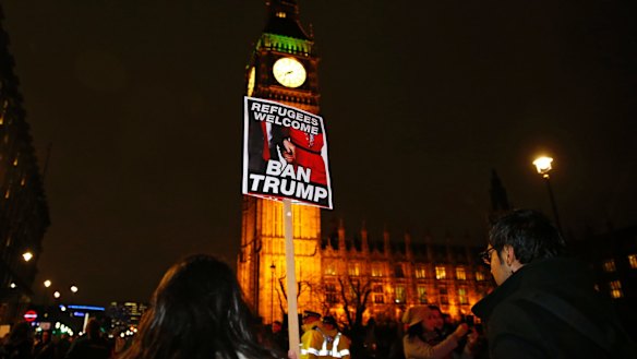 Demonstrators hold a banner during a protest against U.S President Donald Trump's controversial travel ban on refugees and people from seven mainly-Muslim countries, in London, Monday, Jan. 30, 2017. On Friday President Trump signed an executive order halting the US refugee programme for 120 days, indefinitely banning all Syrian refugees and suspended issuing visas for people from Iran, Iraq, Libya, Somalia, Sudan, Syria or Yemen for at least 90 days. (AP Photo/Alastair Grant)