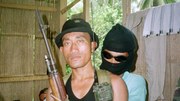Armed Abu Sayyaf rebels guard a group of 21 hostages, including 10 foreigners in a hut at a secret location on this southern Philippine island of Jolo as seen in this April 29, 2000 file photo.  