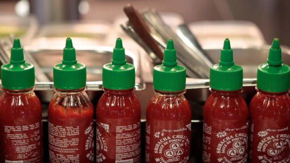 Sriracha bottles lined up at  Momofuku Seiobo, Sydney.