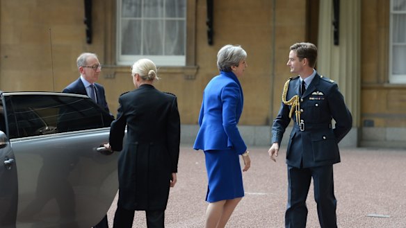 Prime Minister Theresa May with her husband Philip arrives at Buckingham Palace to seek the Queen's permission to form a UK government. 