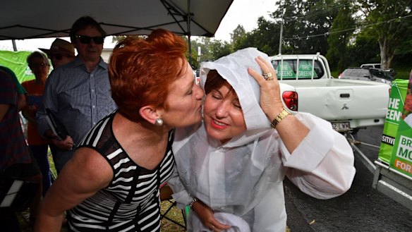 Labor MP Jo-Ann Miller greeted One Nation leader Pauline Hanson with a hug and some booties for her new grandson, despite Labor's attempts to link the resurgent party with the LNP.