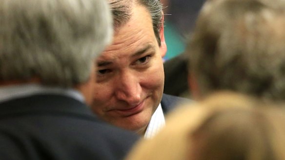 Republican presidential candidate, Senator Ted Cruz, listens to supporters at a caucus site.