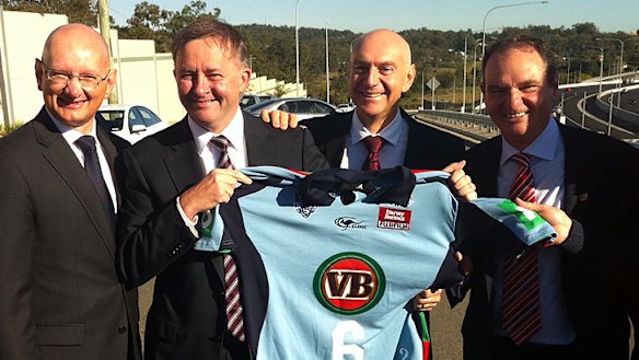 Member for Blair Shayne Neumann, Member for Oxley Bernie Ripoll and Ipswich Mayor Paul Pisasale present rugby league fan and Federal Transport Minister Anthony Albanese with a Blues jersey.