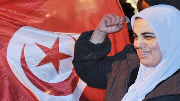 A Tunisian woman celebrates after the announcement that Zine El Abidine Ben Ali has quit as president and fled to Saudi Arabia.