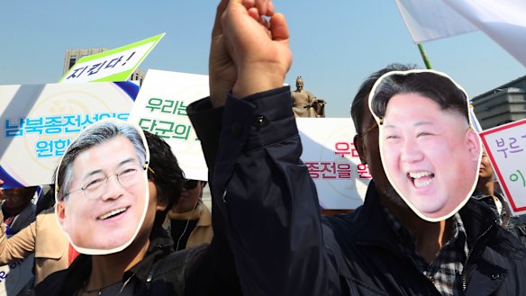 South Korean activists wearing masks of South Korean President Moon Jae-in, left, and North Korean leader Kim Jong-un welcome the planned summit between the leaders.
