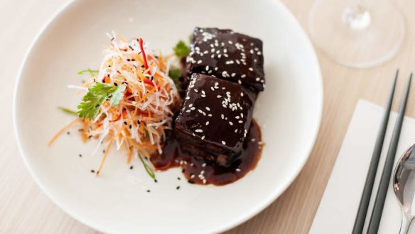 Sticky twice-cooked pork belly with carrot and daikon salad.