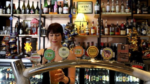 Top taps ... Freya Simmons works the bar at Archive Beer Boutique in West End.