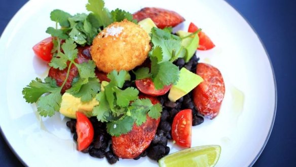 Crispy rolled egg with black beans and chorizo.