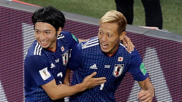 Looking sharp: Keisuke Honda, right, celebrates with teammate Gaku Shibasaki after scoring.