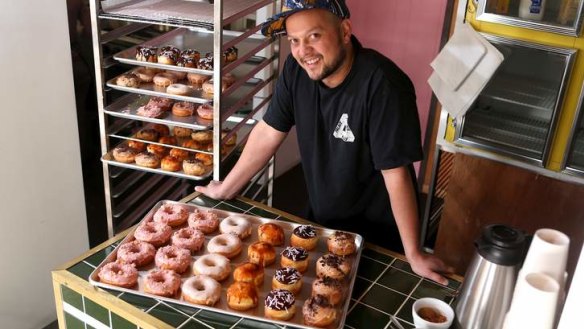 Raph Rashid with a tray of his fluffy doughnuts.