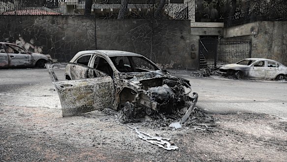 Cars were destroyed by the wildfires near the village of Neos Voutzas near Athens.