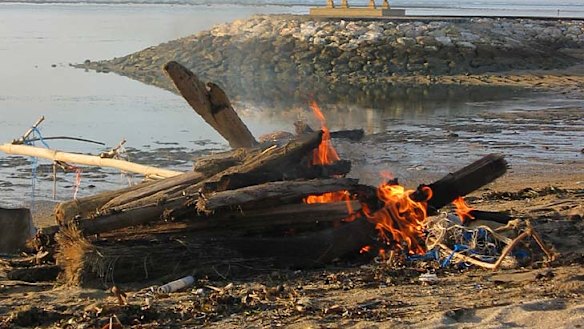 Pollution ... rubbish burns on a beach in Bali.