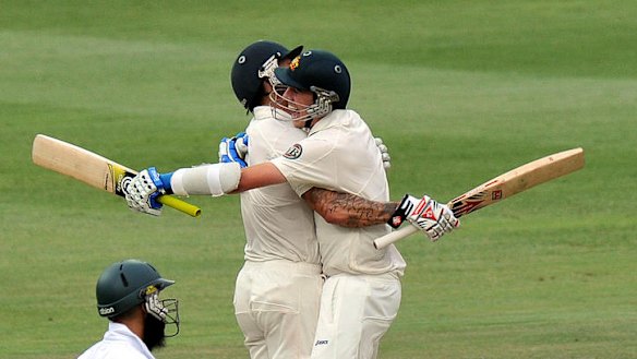 Australian cricketers Mitchell Johnson (left) and Patrick Cummins celebrate victory in the second Test against South Africa at Johannesburg.